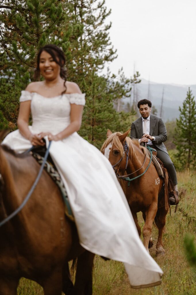 Bride and groom riding horses in Grand Lake, Colorado