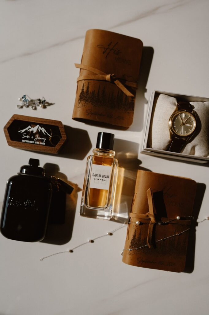 Wedding details including cologne, vow books, and rings