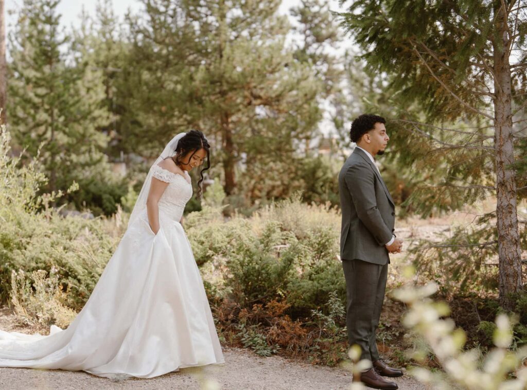 Bride and groom share a first look in the forest