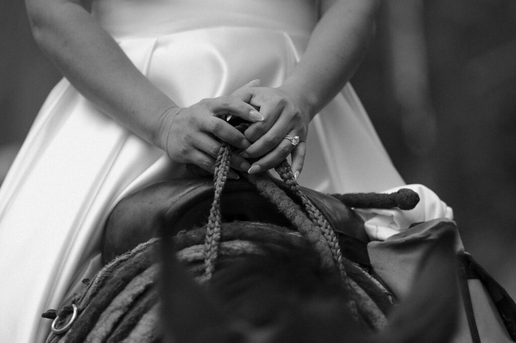 Wedding ring detail photo on horse saddle