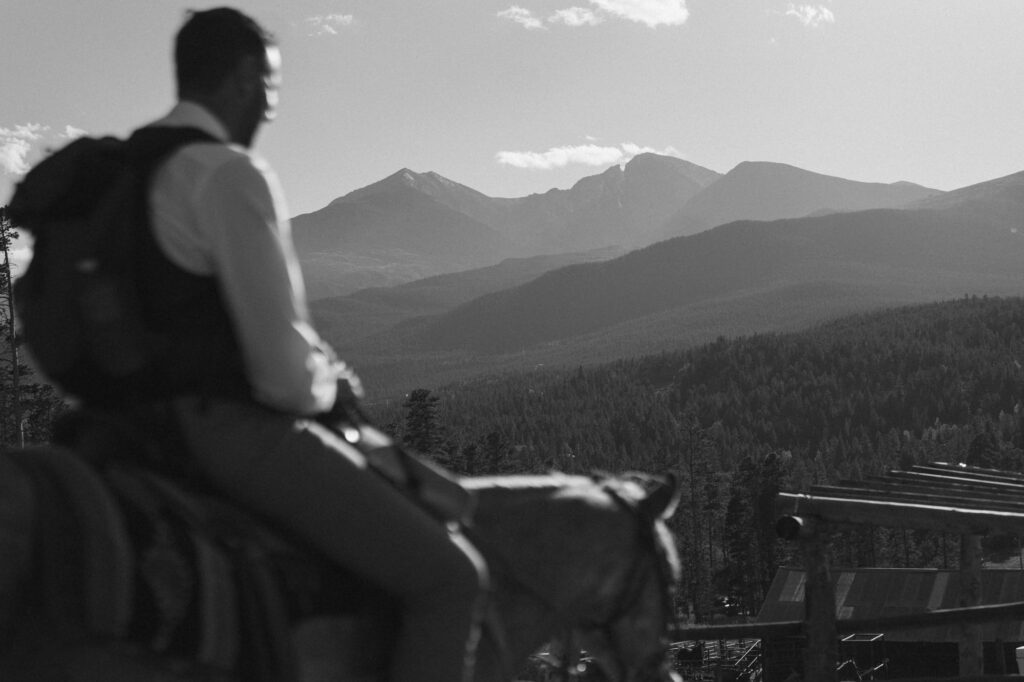 Groom on horseback in Colorado mountains