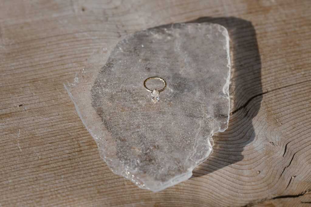 Engagement ring on a chunk of ice during November surprise engagement
