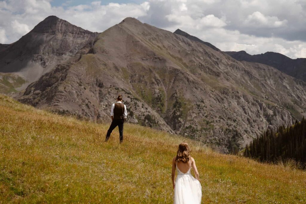 Bride and groom about to share a first look on a Colorado mountainside
