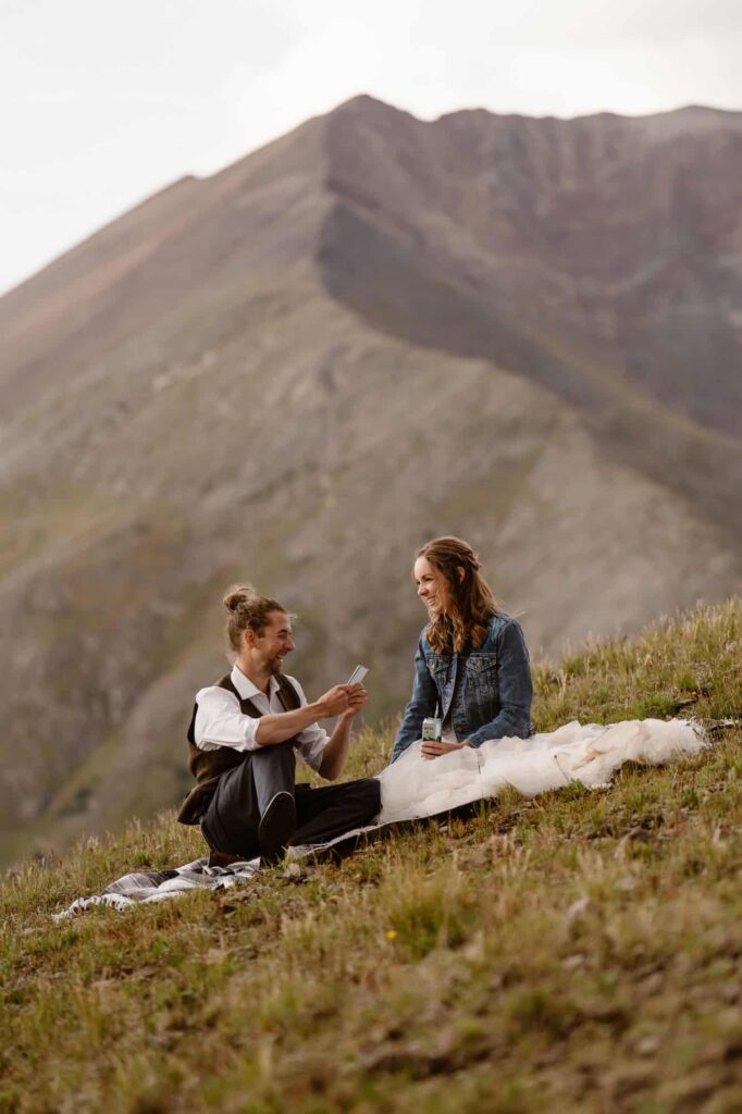 Reading wedding vows sitting down outside of Colorado cabin