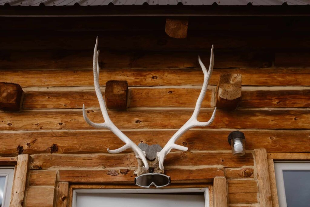 Antlers above cabin door with snowboard gogglees