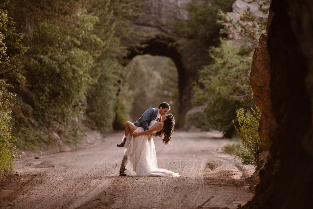 Bride and groom dip kissing in Colorado mountains