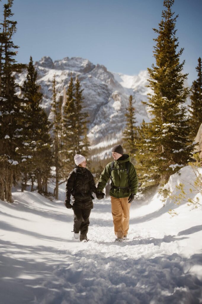 Couple at a mountain lake after surprise hiking proposal