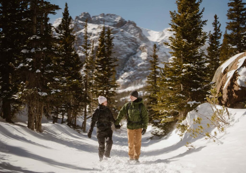 Couple hiking down from The Loch after a surprise proposal in winter