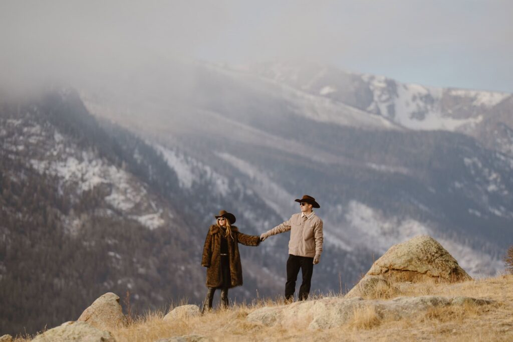 Couple dresses in western attire for their Colorado mountain engagement photos