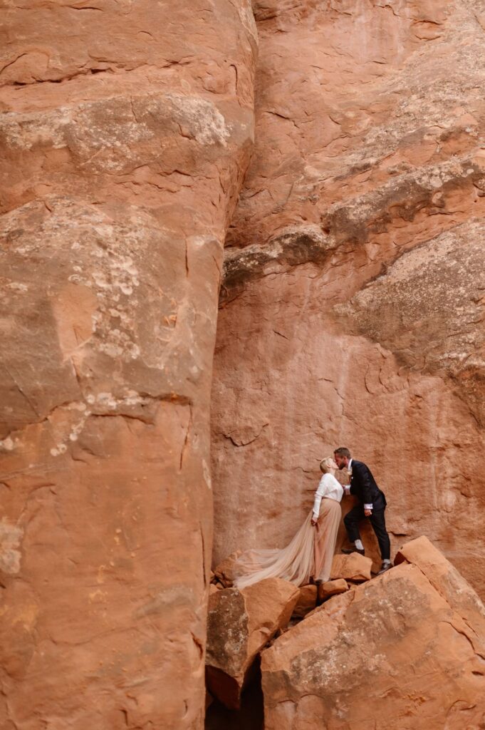 Desert elopement photos with red rock wall