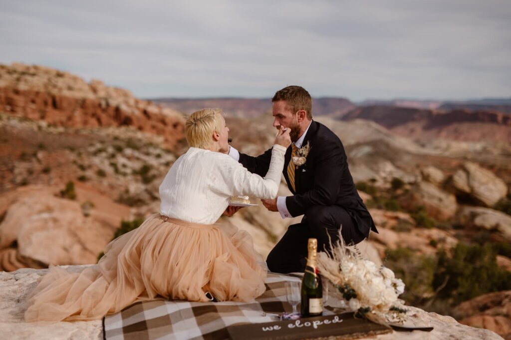 Bride and groom share picnic on elopement day