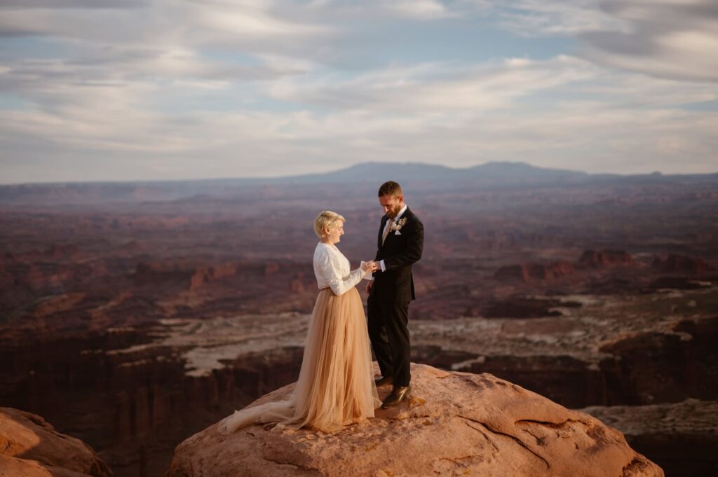 Elopement ceremony at sunset on cliff edge