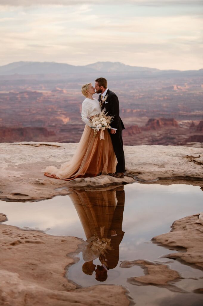 Canyonlands National Park wedding photos of couple on the edge of a cliff