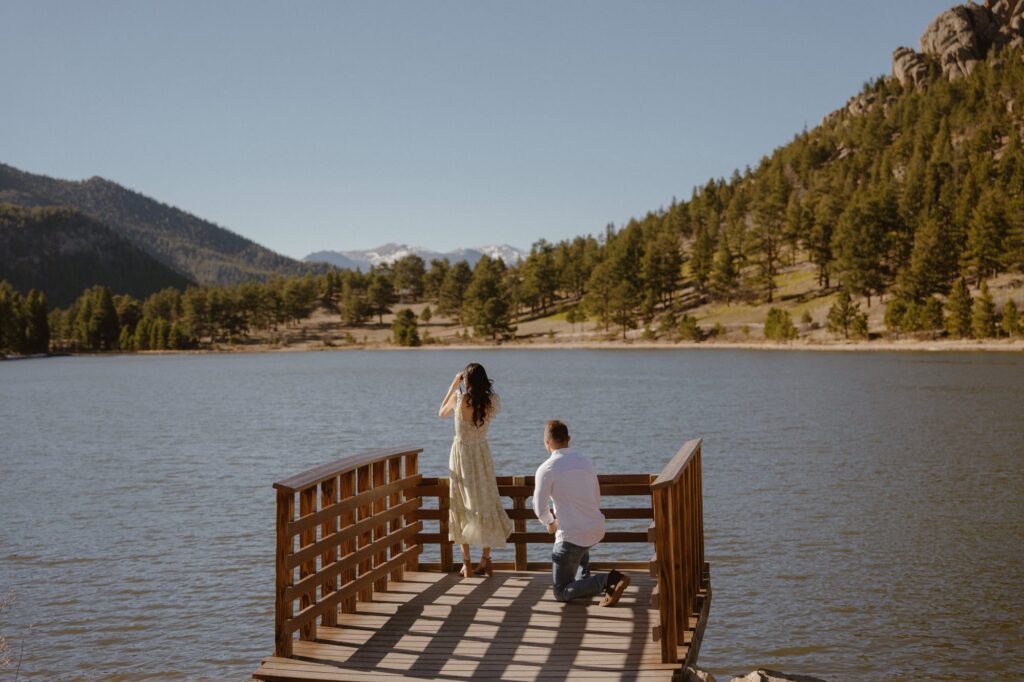 A surprise proposal on the small lake dock at Lily Lake in Estes Park