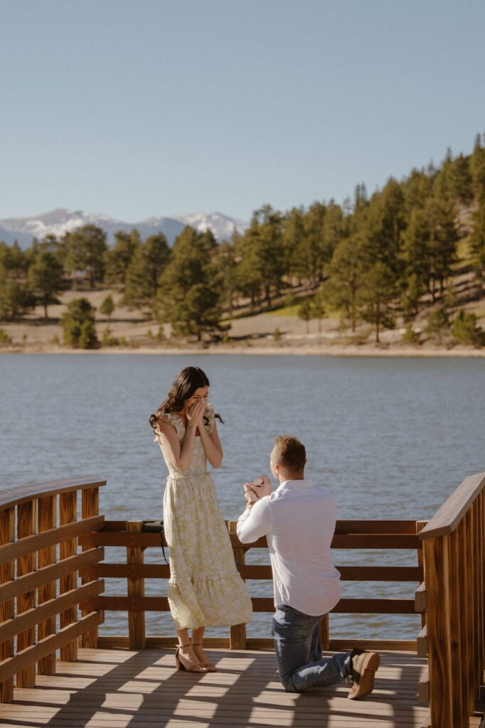 Surprised reaction to surprise proposal at Lily Lake dock in Estes Park