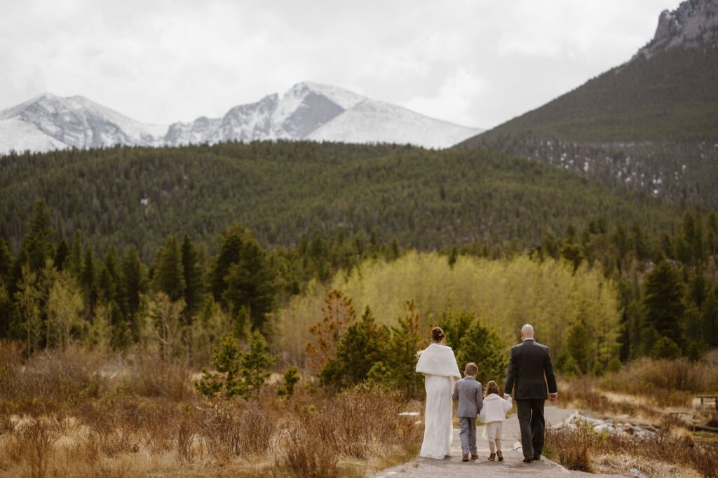 Family walking at Lily Lake in Rocky Mountain National Park after vow renewal