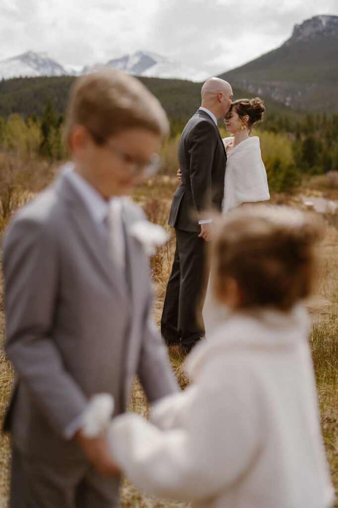 Creative wedding portrait with children in the mountains