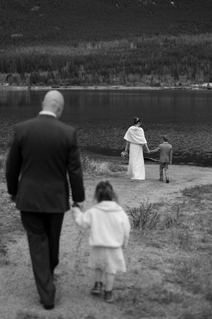 Bride and groom walking with children