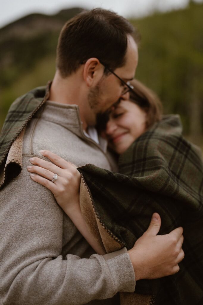 Couple wrapped in a plaid blanket