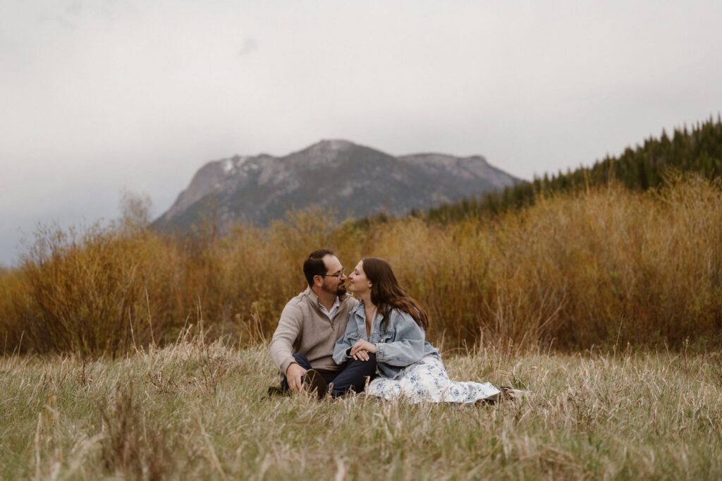 Romantic engagement photoshoot in a mountain meadow in Estes Park