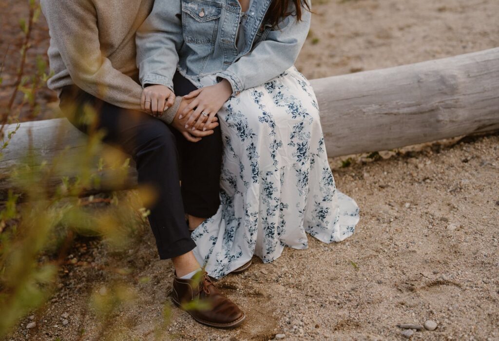 Couple sitting on a log during couples photoshoot