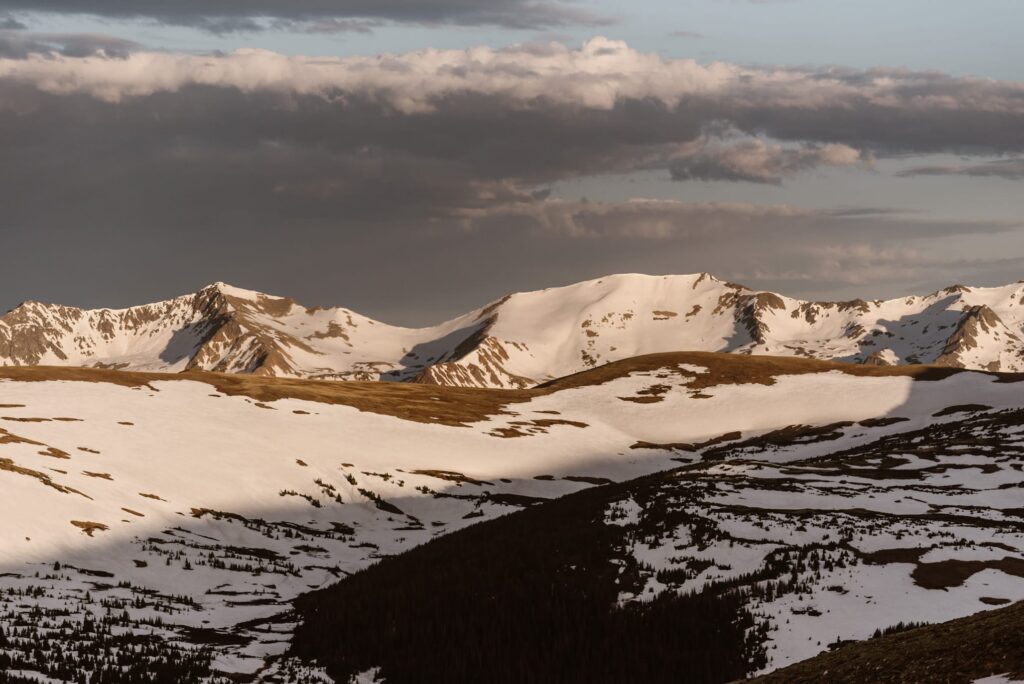 Sunrise on Trail Ridge Road with snowy mountains in June