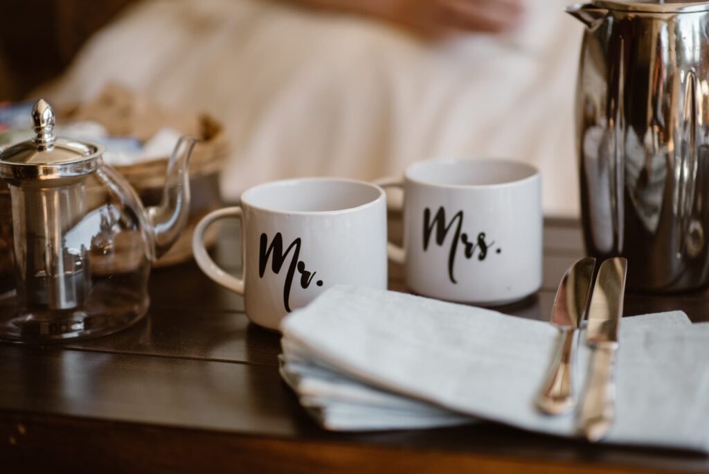 Mr & Mrs wedding day mugs in front of a tea spread