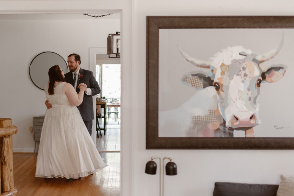 bride and groom having a first dance in a beautiful modern living room