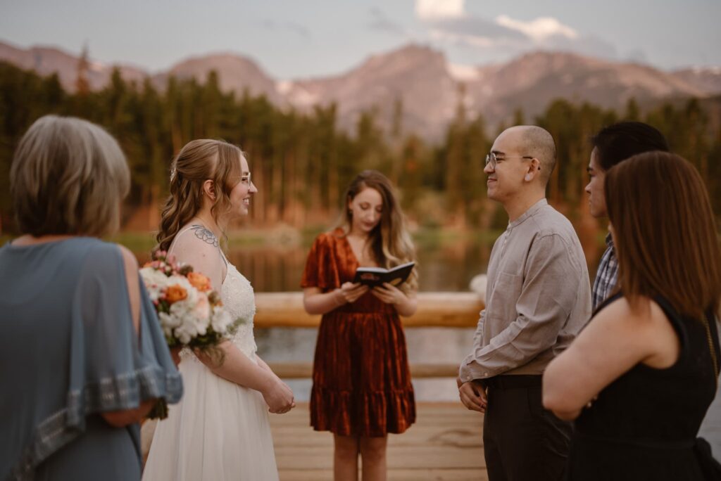 Couple getting married on the dock at Sprague Lake in Rocky Mountain National Park