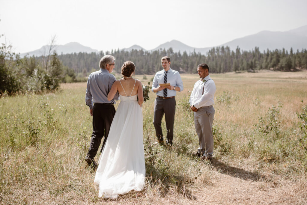 Couple getting married in a meadow in Colorado