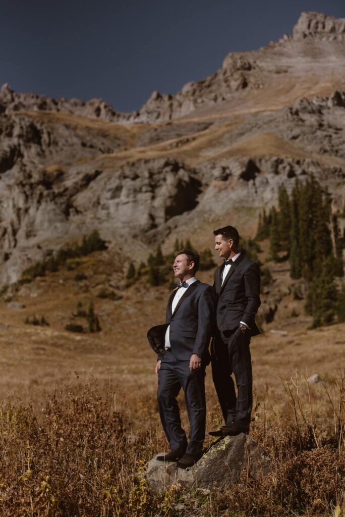 same-sex couple standing in the mountains during their off-roading wedding