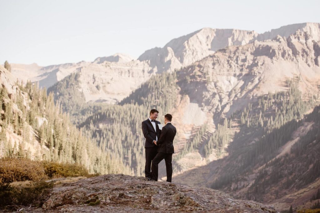 couple standing in the mountains of Colorado and exchanging vows