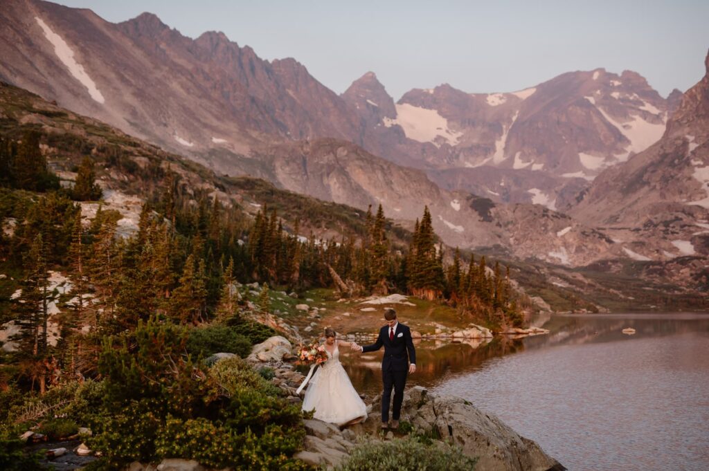 Colorado elopement photographer captures couple hiking in their wedding attire in the mountains