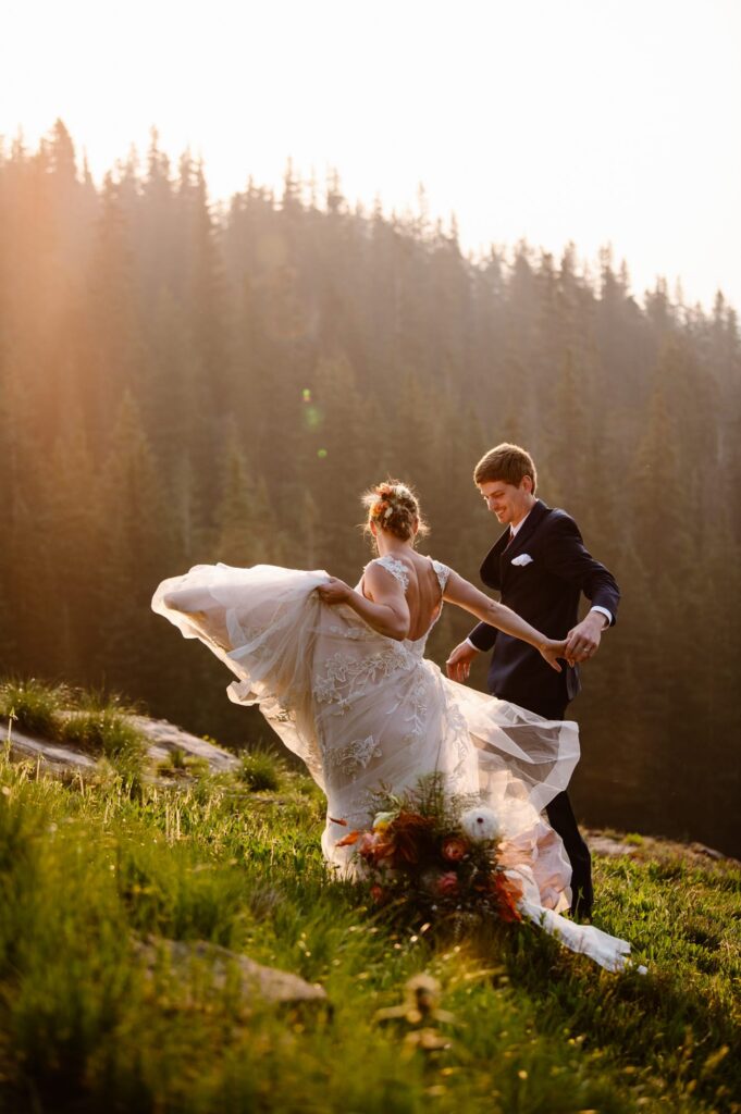 Colorado elopement photographer captures couple spinning on the mountainside