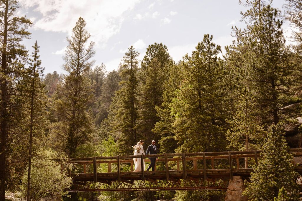 couple walking across the bridge at their June Colorado elopement