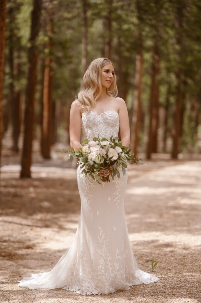 bride with bouquet in the woods of Estes Park