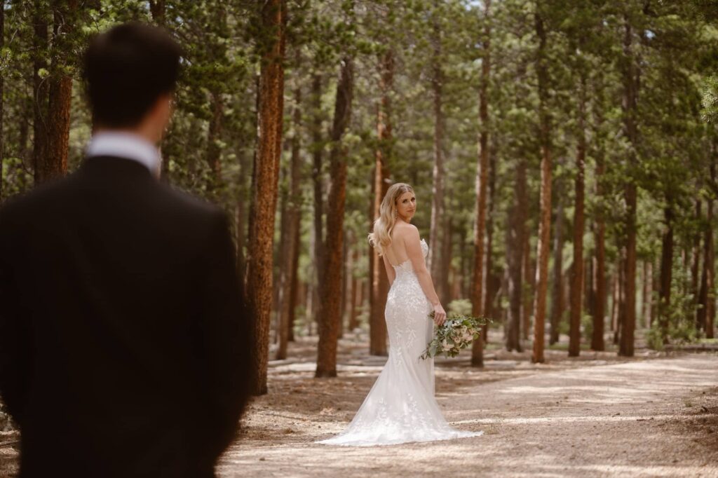 Couple on a wooded dirt road at their Estes Park wedding 