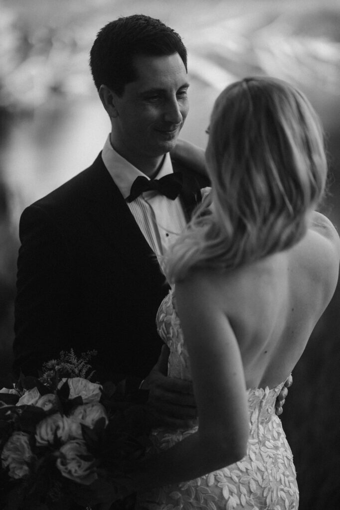 black and white photo of groom looking at his bride