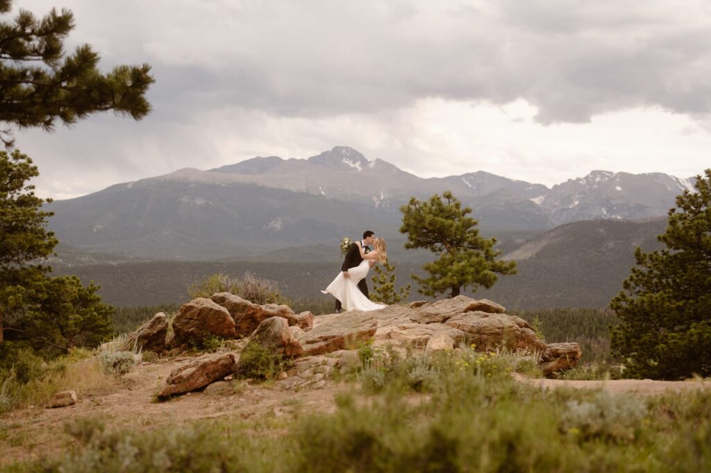 Couple at rocky outcropping at 3M Curve in Rocky Mountain National Park