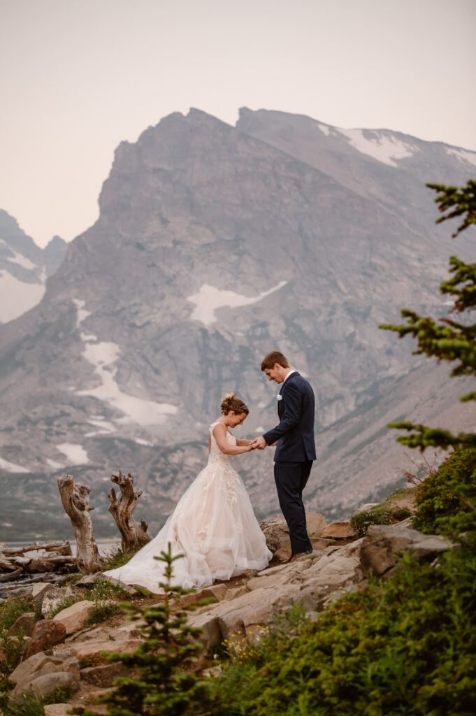 couple having a first look in front of the mountains