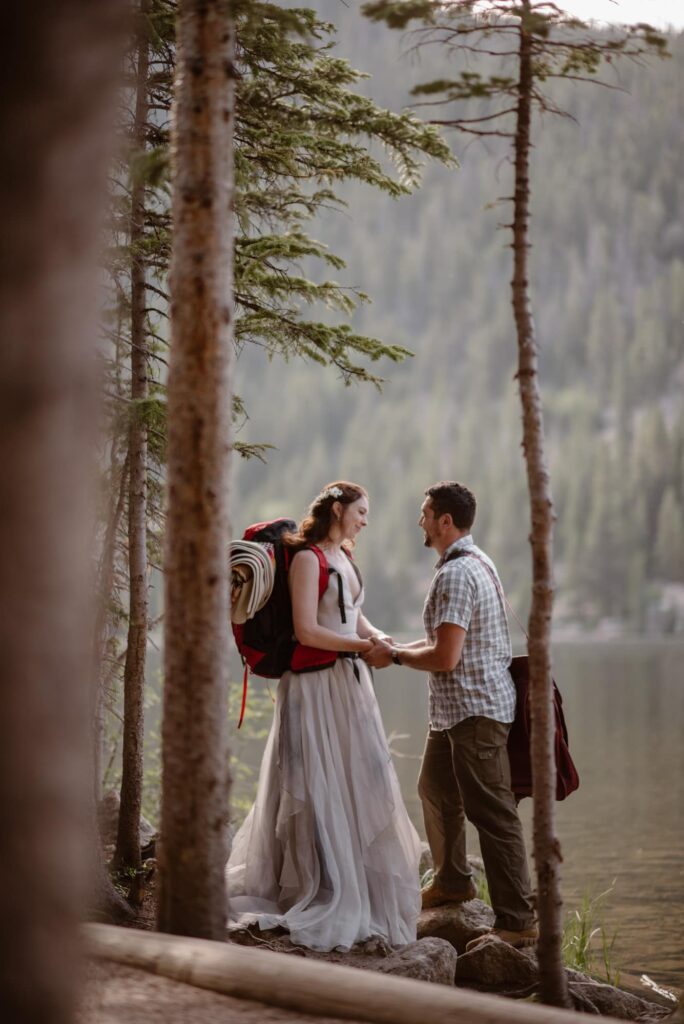Couple standing at the edge of Bear Lake in their wedding attire