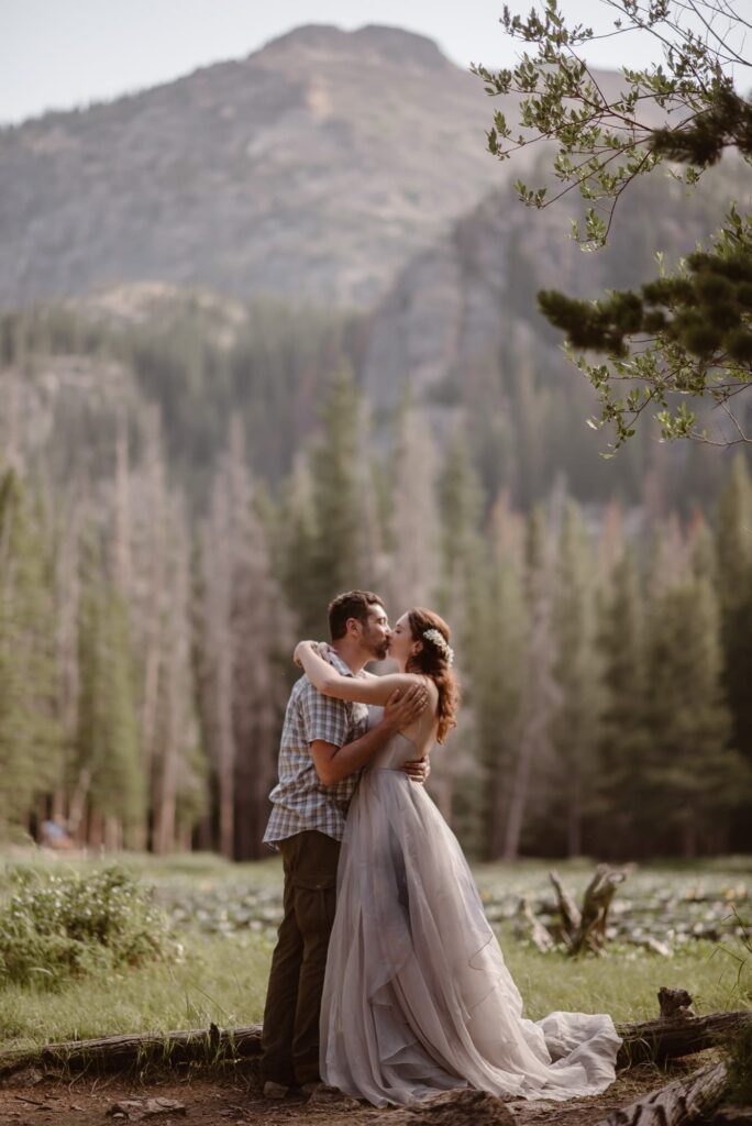Couple kissing with Colorado mountains in the background