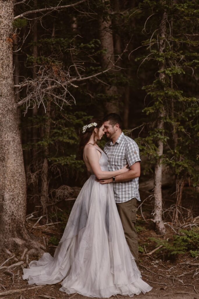 Bride and groom in the forest of Rocky Mountain National Park
