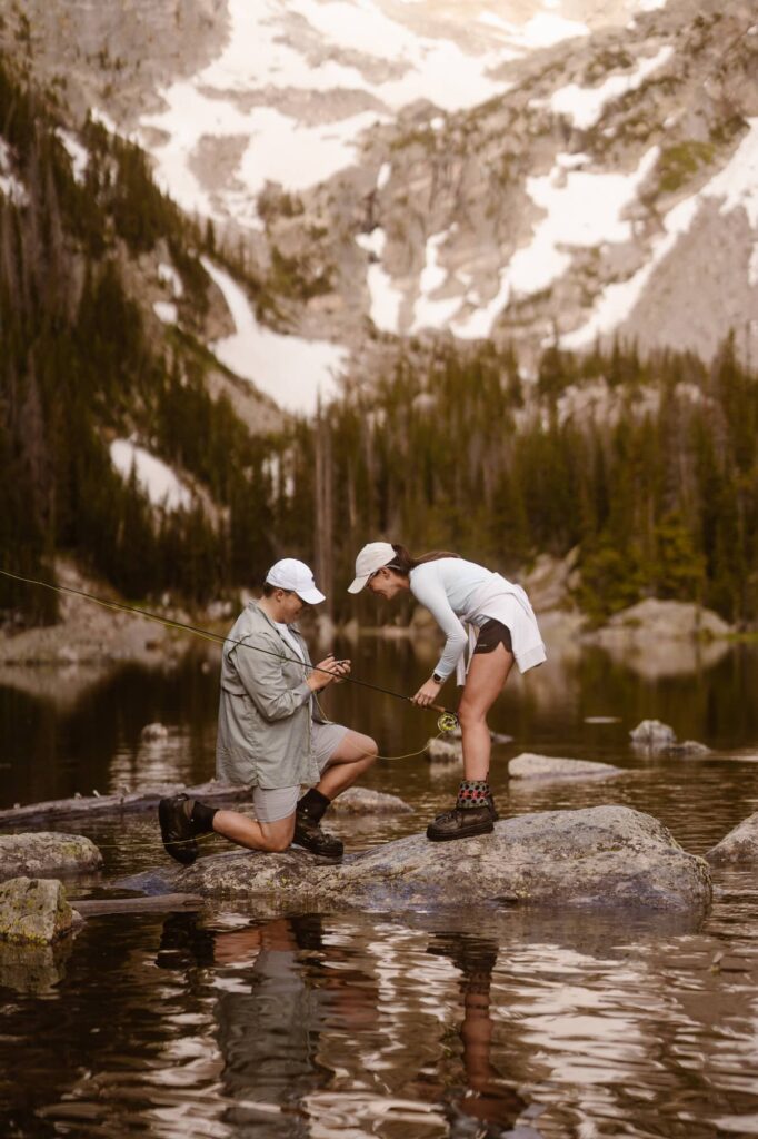 Close up of fly fishing surprise proposal in Colorado