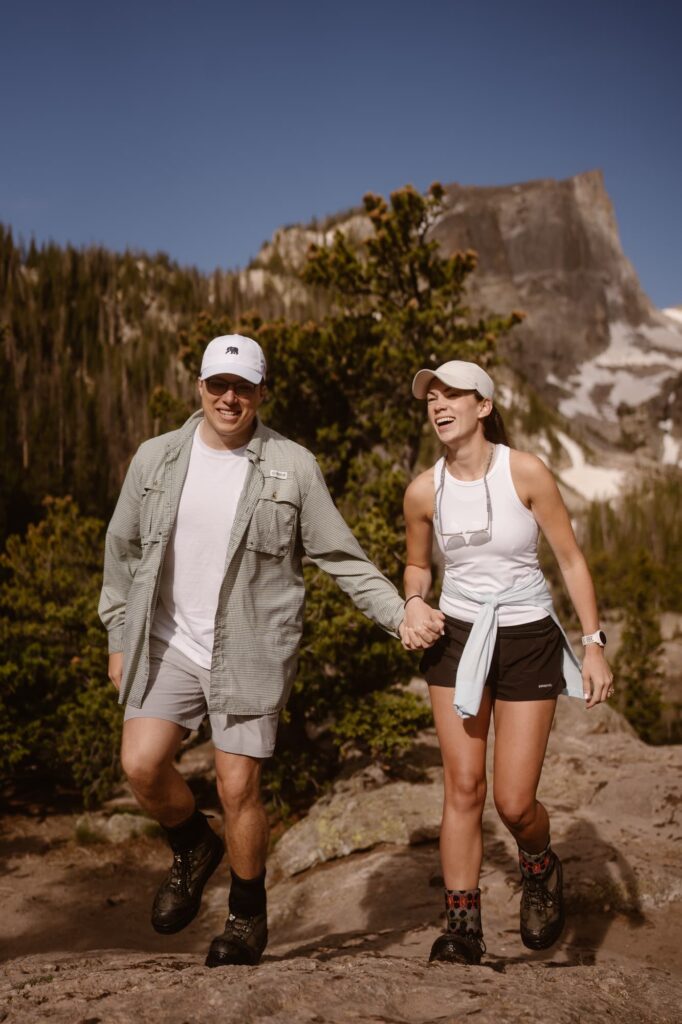 Happy couple after surprise proposal at Dream Lake in Colorado