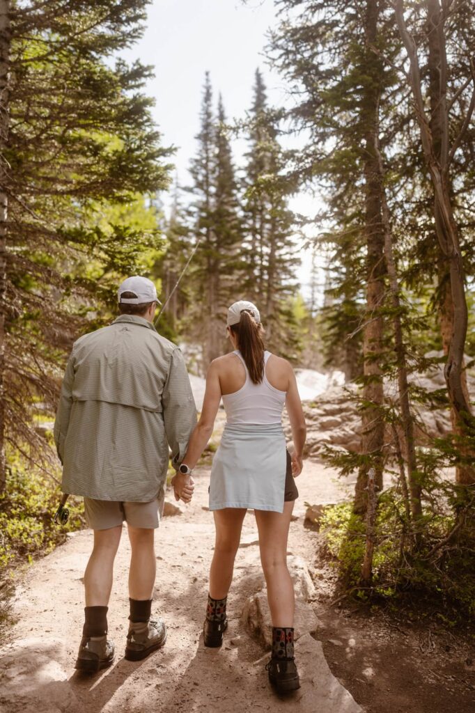 Couple walking around Dream Lake after proposal