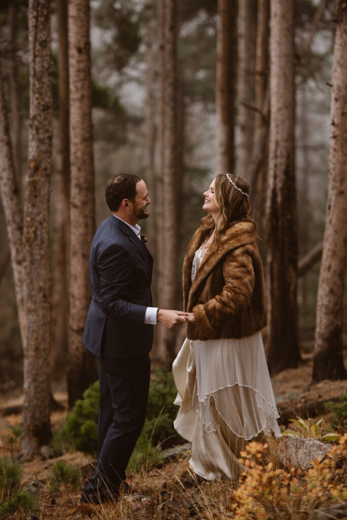 Couple looking at each other in a foggy forest