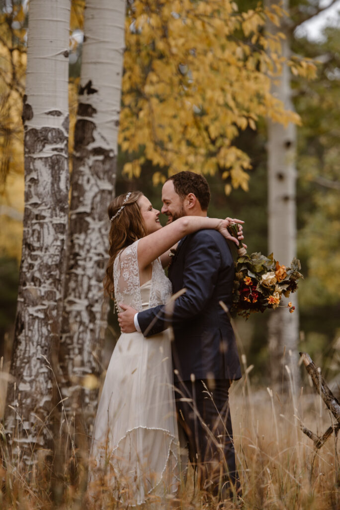 Couple in the aspen grove in Estes Park Colorado in October