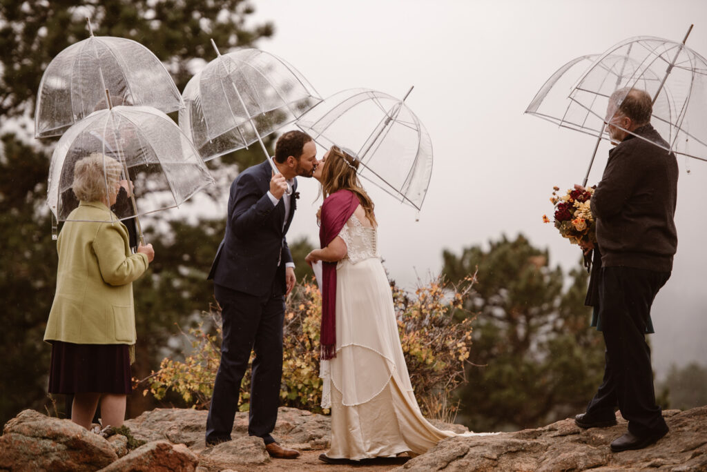 First kiss at couples Estes Park wedding in October