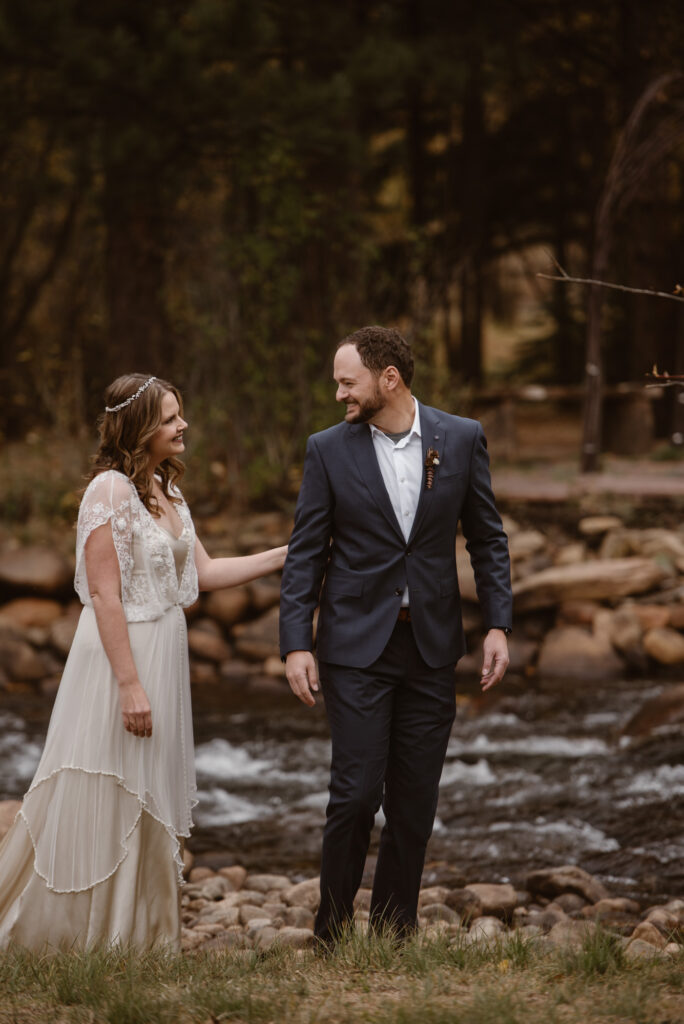 Couple sharing a wedding day first look with October fall foliage 